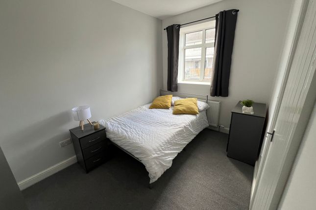 A Cozy Double Bedroom Featuring A Neatly Made Bed ...