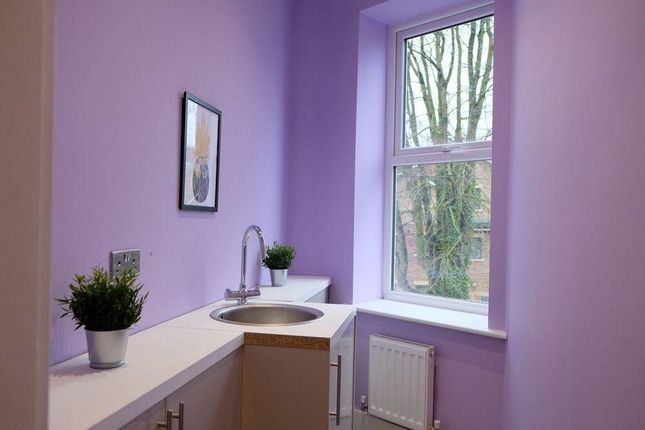 A Compact, Clean Kitchen Space Painted In A Soft P...