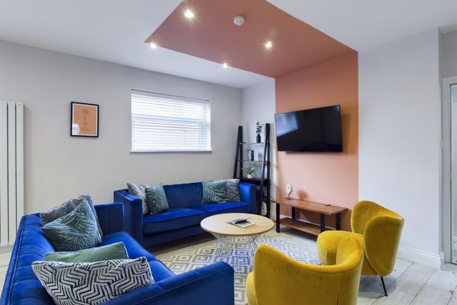 A Spacious And Inviting Modern Living Room With St...