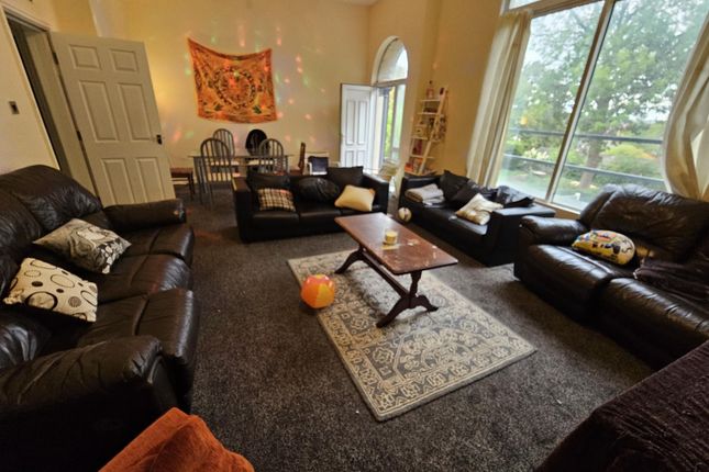 A Spacious And Inviting Living Room Filled With Am...