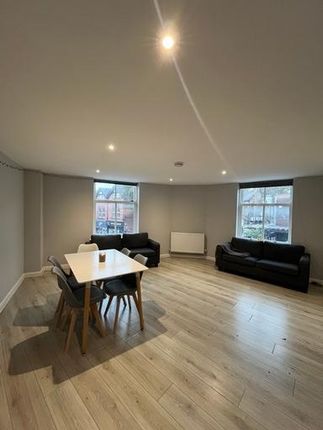 A Bright And Spacious Living Room With Large Windo...