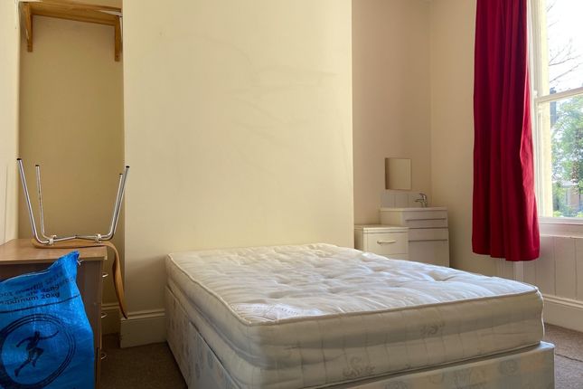 A Cozy Bedroom With Natural Light Streaming Throug...