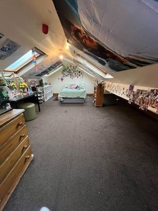 A Cozy Bedroom With A Single Bed, Well-Lit With Am...