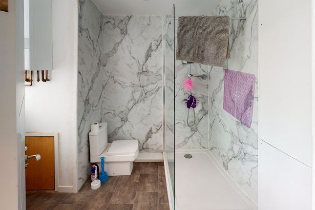 A Modern Bathroom Featuring Marble Walls And A Cle...