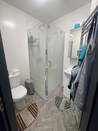 A Modern And Tidy Bathroom Featuring A Glass-Enclo...
