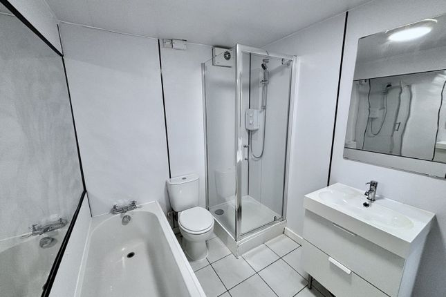 A Spacious And Modern Bathroom Featuring Both A Ba...