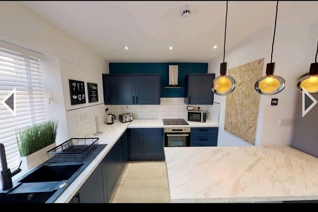 A Modern, Stylish Kitchen Featuring Sleek Navy Cab...