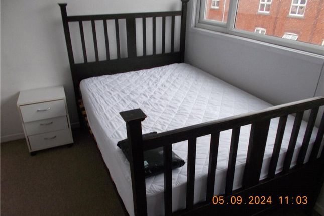 A Bright Double Bedroom Featuring A Sleek Black Wo...