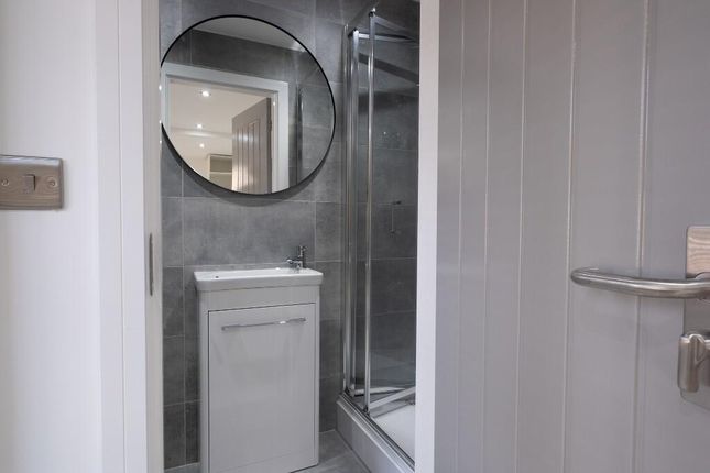 A Clean And Modern Bathroom Featuring A Shower Cub...
