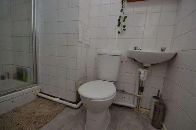 A Small Bathroom Featuring A Shower, Toilet, And S...