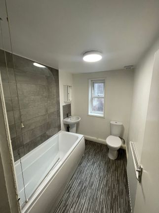 A Spacious And Modern Bathroom Featuring A Bath An...