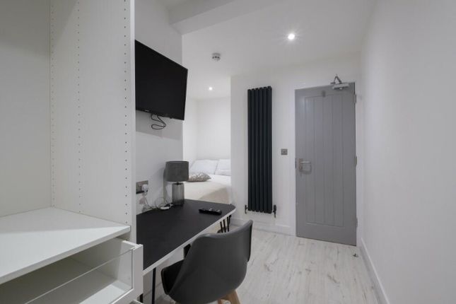 A Stylish Double Bedroom Featuring A Comfortable B...