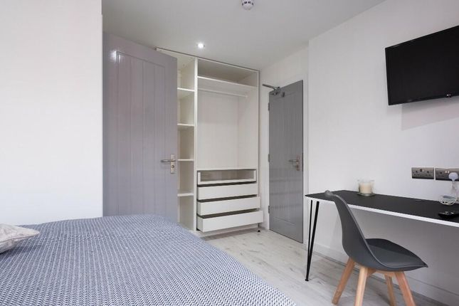 A Modern, Well-Maintained Bedroom Featuring A Comf...