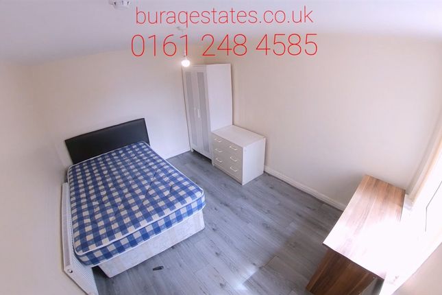 A Cozy Single Bedroom Featuring A Bed With A Check...