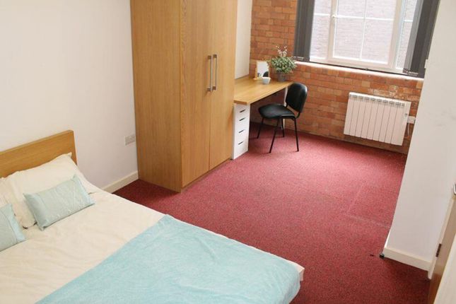 A Cozy Double Bedroom Featuring A Comfortable Bed,...