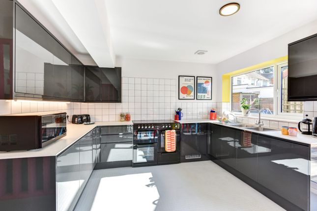 Modern And Well-Lit Kitchen With Sleek Black Cabin...