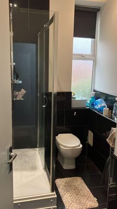 Modern Bathroom With A Glass Shower Enclosure, Til...