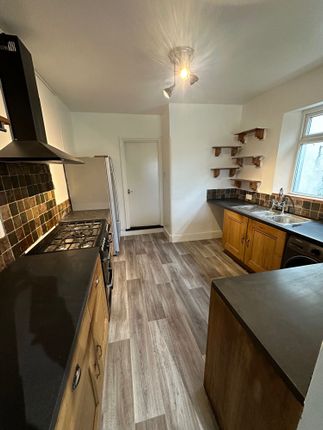 A Well-Maintained Galley Kitchen Featuring Wooden ...