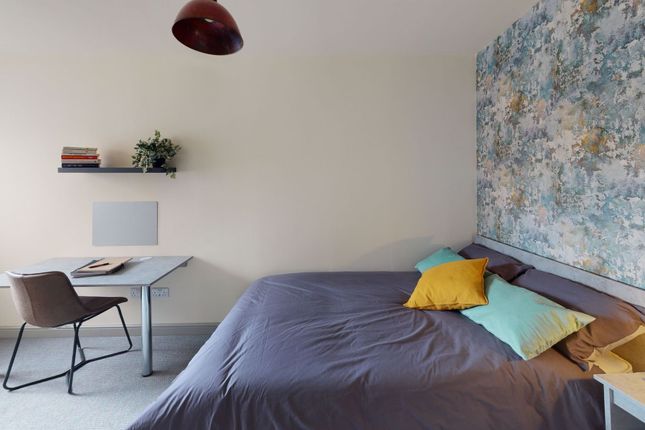 A Modern Bedroom Featuring A Comfortable Bed With ...