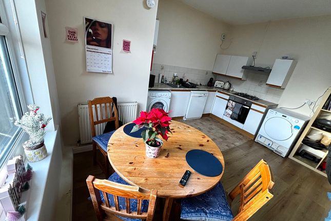 Bright Open Kitchen-Diner With A Round Wooden Tabl...