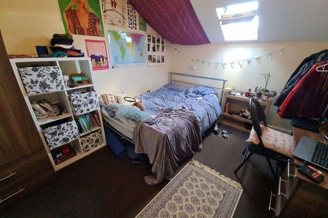 A Cozy Single Bedroom Featuring A Comfortable Bed,...