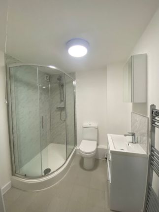 Bright And Modern Bathroom Featuring A Shower Encl...