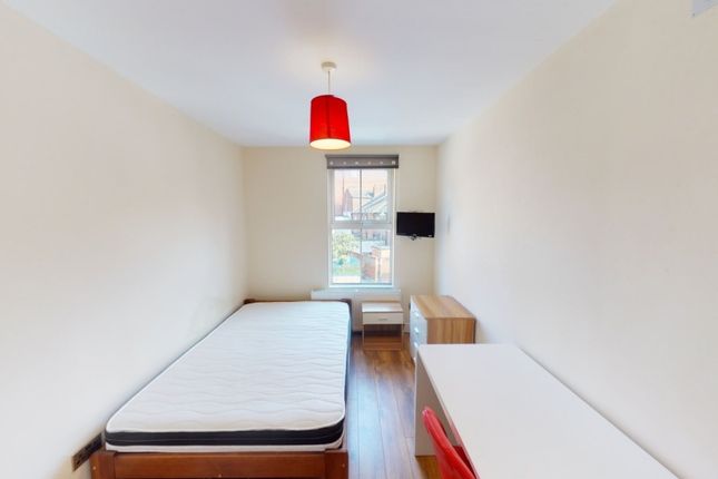 A Neat And Simple Single Bedroom Featuring A Bed, ...