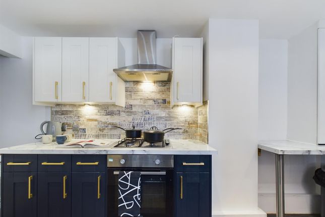 A Modern And Stylish Kitchenette With Ample Storag...