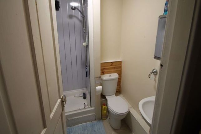 A Clean And Tidy Bathroom Featuring A Shower Unit,...