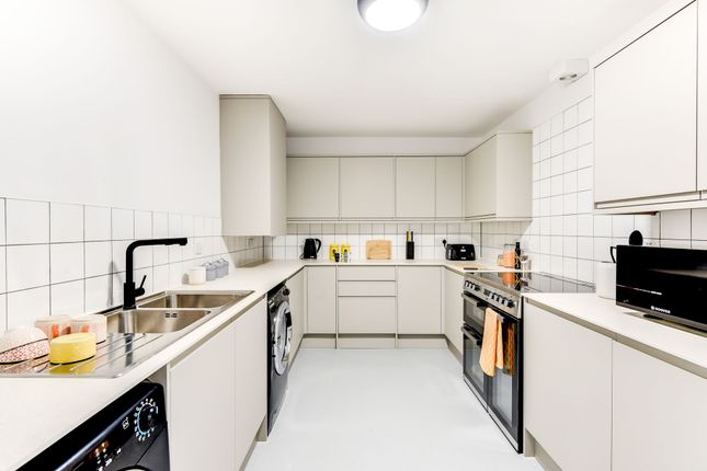 Modern Kitchen Featuring Sleek Cabinetry, Ample Co...