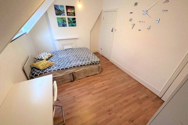 A Cozy Double Bedroom Featuring A Neatly Made Bed ...
