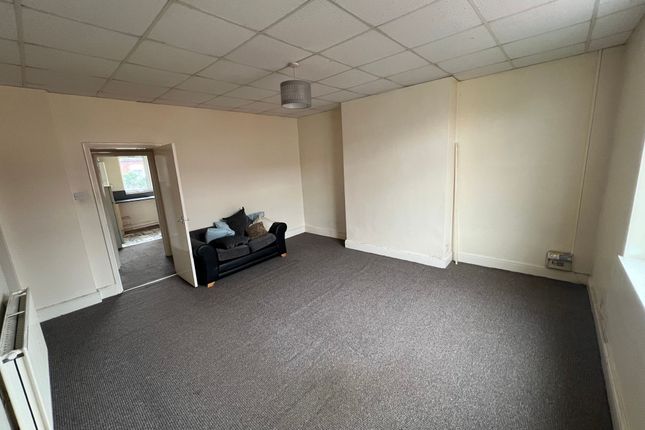 A Spacious Living Room With Neutral Walls And A La...