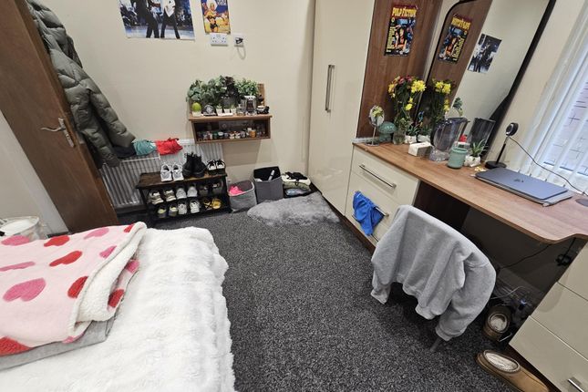 A Well-Maintained Bedroom Featuring A Cozy Bed Wit...