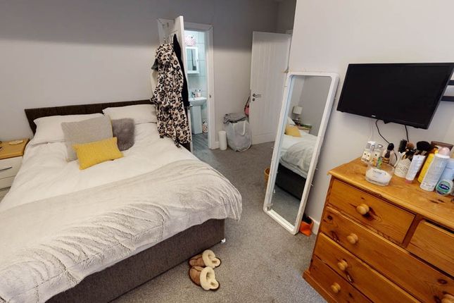 A Cozy Bedroom Featuring A Large Bed With A Comfor...