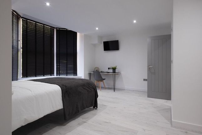 A Spacious And Modern Master Bedroom With A Large ...