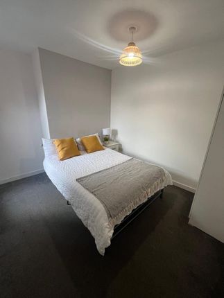A Cozy And Neatly Arranged Double Bedroom Featurin...