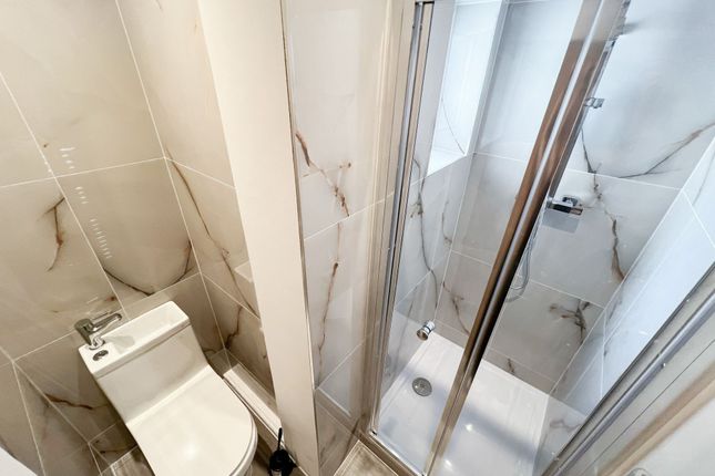 Modern Bathroom Featuring A Sleek Glass Shower Enc...