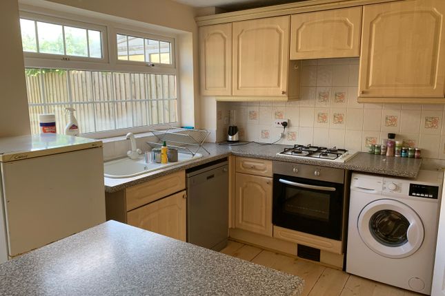 A Bright And Tidy Kitchen With Ample Storage And m...