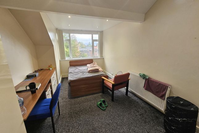 A Cozy Bedroom Featuring A Double Bed Against The ...