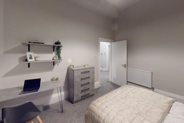 A Spacious And Tidy Double Bedroom Featuring A Des...