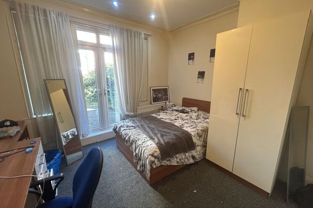 A Well-Lit Double Bedroom Featuring A Secure Wardr...