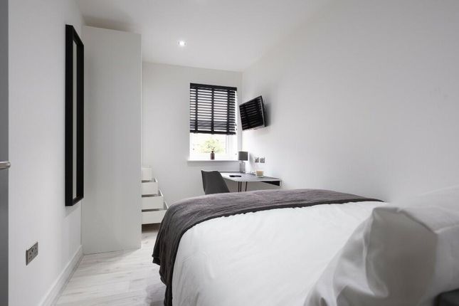 A Bright And Clean Bedroom Featuring A Comfortable...