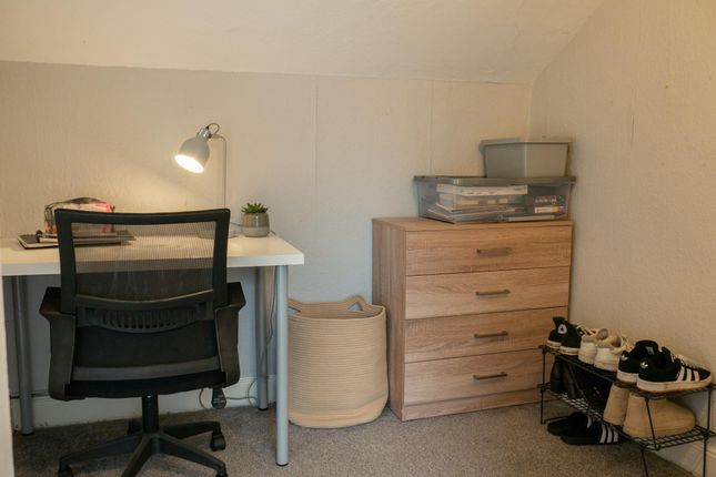 A Compact Study Area Featuring A Desk With A Chair...