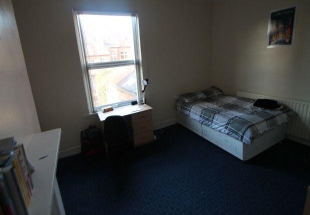 A Cozy Bedroom Featuring A Double Bed Placed Again...