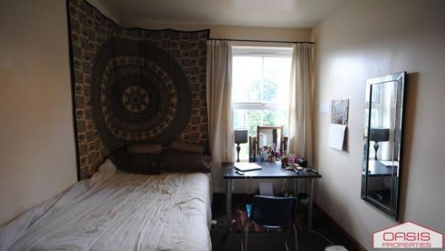 A Cozy Bedroom With A Large Bed, Window Allowing N...