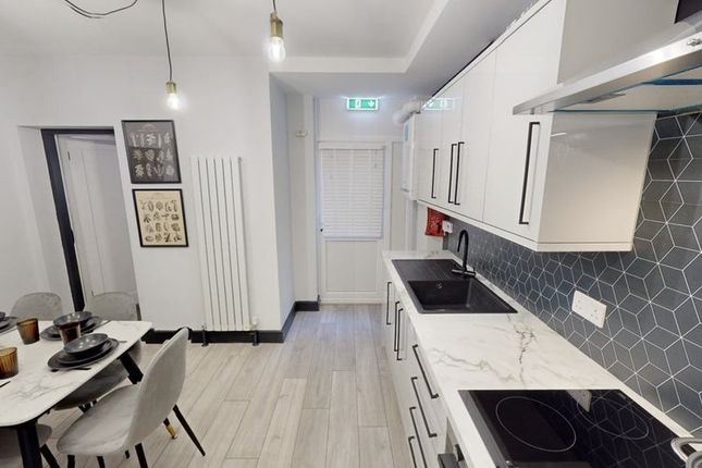 Modern Kitchen With Sleek White Cabinetry, A Marbl...