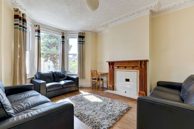 A Bright And Inviting Living Room Featuring Three ...