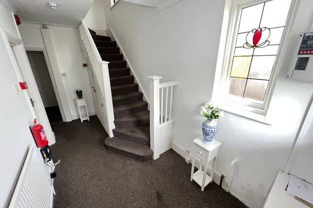 Bright Hallway Featuring A Decorative Stained Glas...