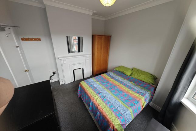 A Cozy Double Bedroom Featuring A Comfortable Doub...