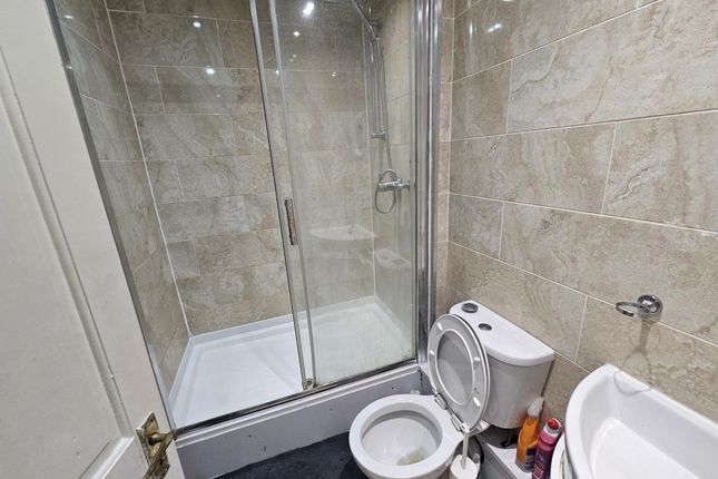 A Spacious And Modern Bathroom Featuring A Large S...